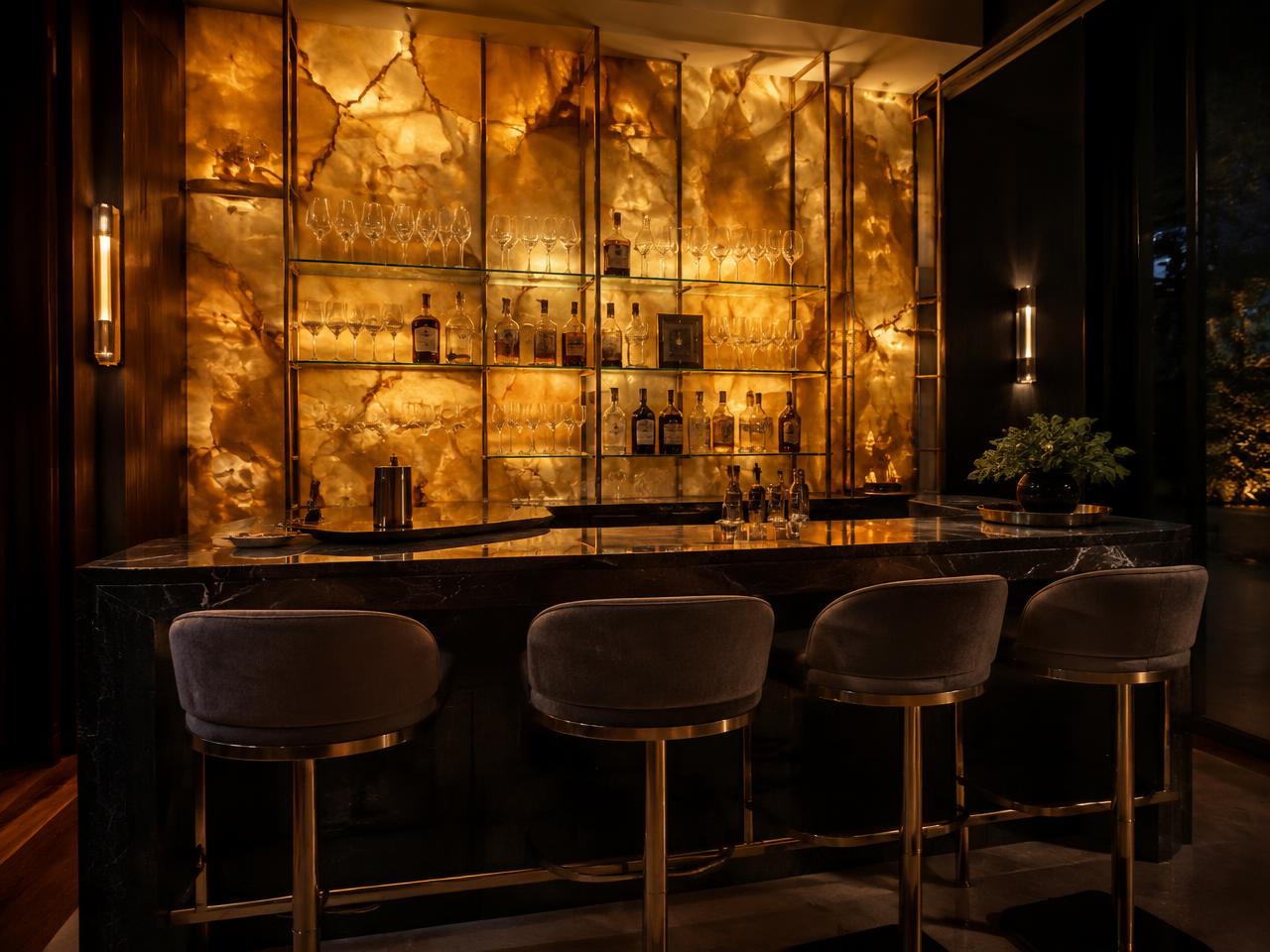 Backlit honey onyx bar wall with dark stone counter